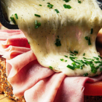 Delicious Raclette Cheese Melted On Top Of A Ham